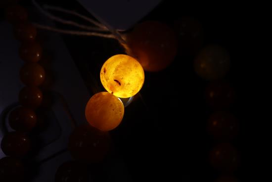 A single strand amber bead necklace, gross weight 28 grams and two other necklaces.